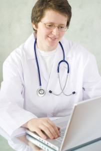 Doctor and computer healthcare records.